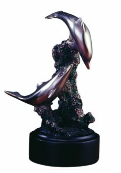 Two Dolphins Playing Among The Rocks